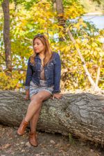 Franchesca McMenemy sitting on a log Franchesca McMenemy