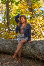 Franchesca McMenemy sitting on a log Franchesca McMenemy