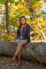 Franchesca McMenemy sitting on a log Franchesca McMenemy